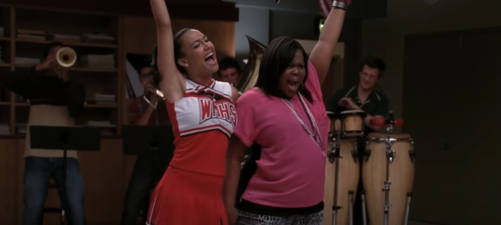 Santana Lopez wears her cheerleading uniform and Mercedes Jones wears a brightly colored shirt
