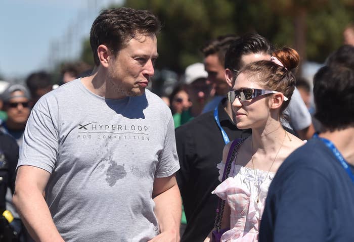 Elon and Grimes walking outside together