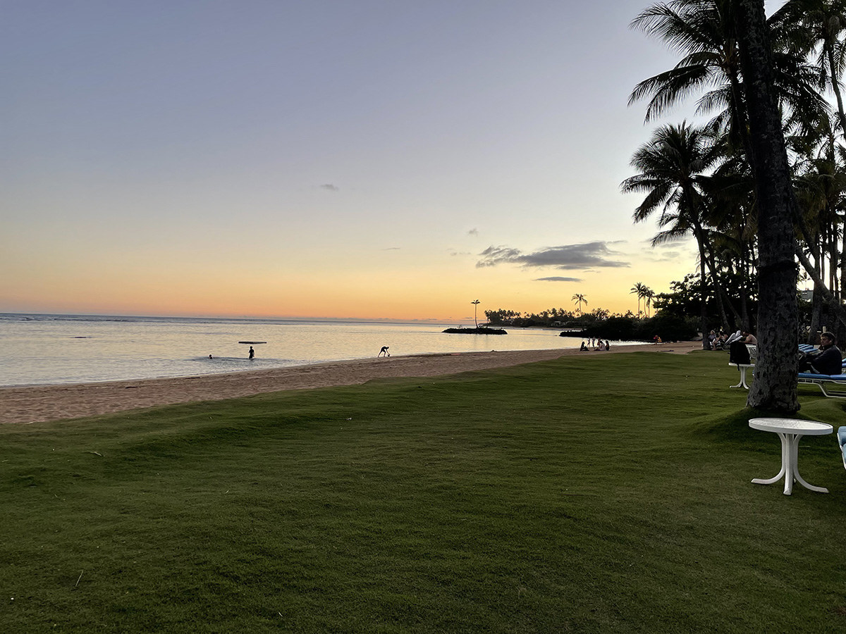 A view of the beach at the Kahala Hotel at sunset