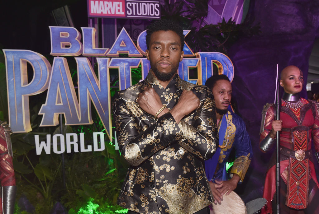 on the red carpet at the &quot;Black Panther&quot; premiere, Boseman does the &quot;Wakanda Forever&quot; pose
