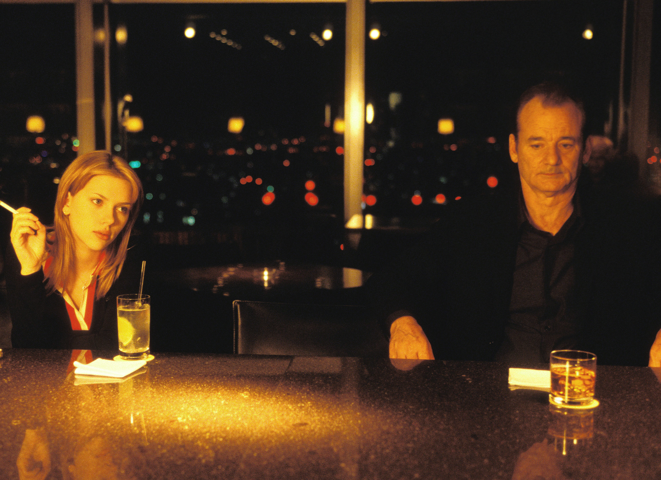Scarlett Johansson, Bill Murray sit at a hotel bar drinking, side by side at night