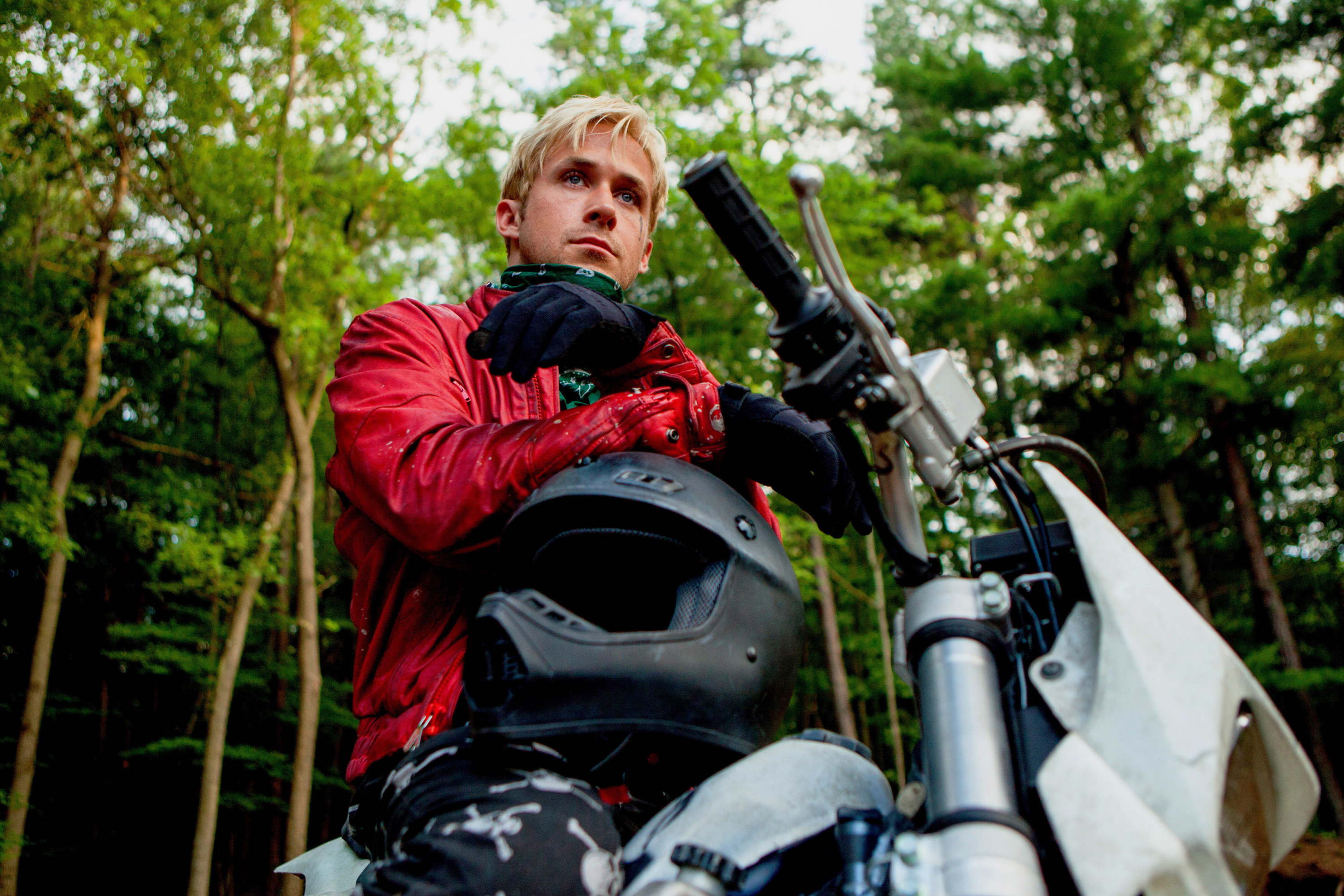 Ryan Gosling wearing leather, sitting on a motorbike