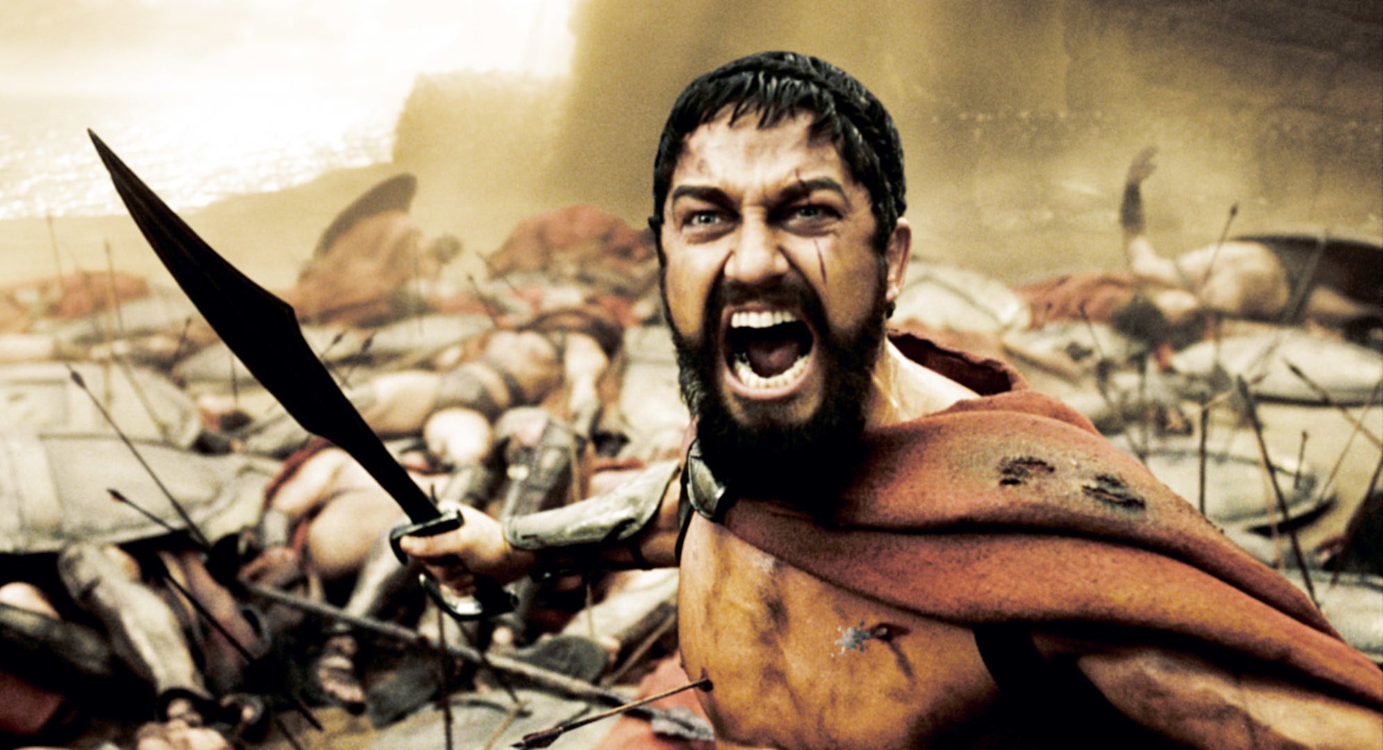Gerard Butler in 300 holding a large knife and looking fierce
