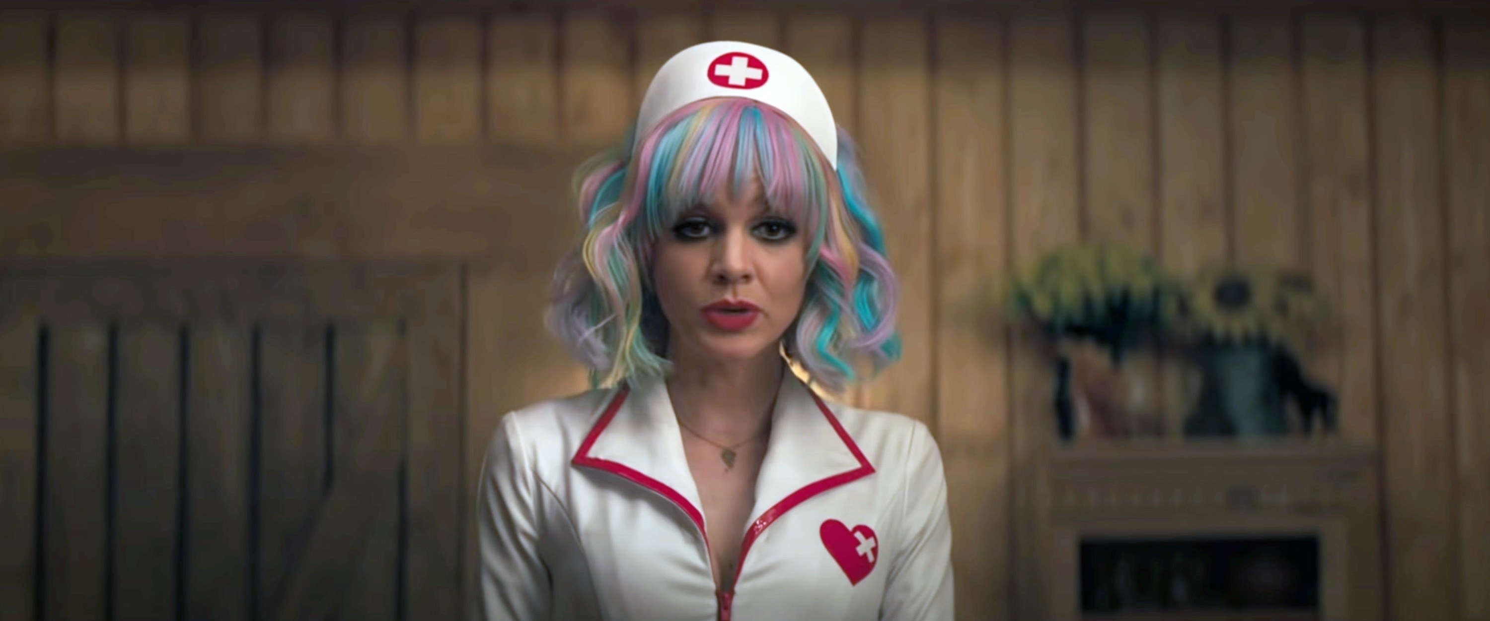 Carey Mulligan with pastel multicolor hair, in a costume nurse&#x27;s outfit