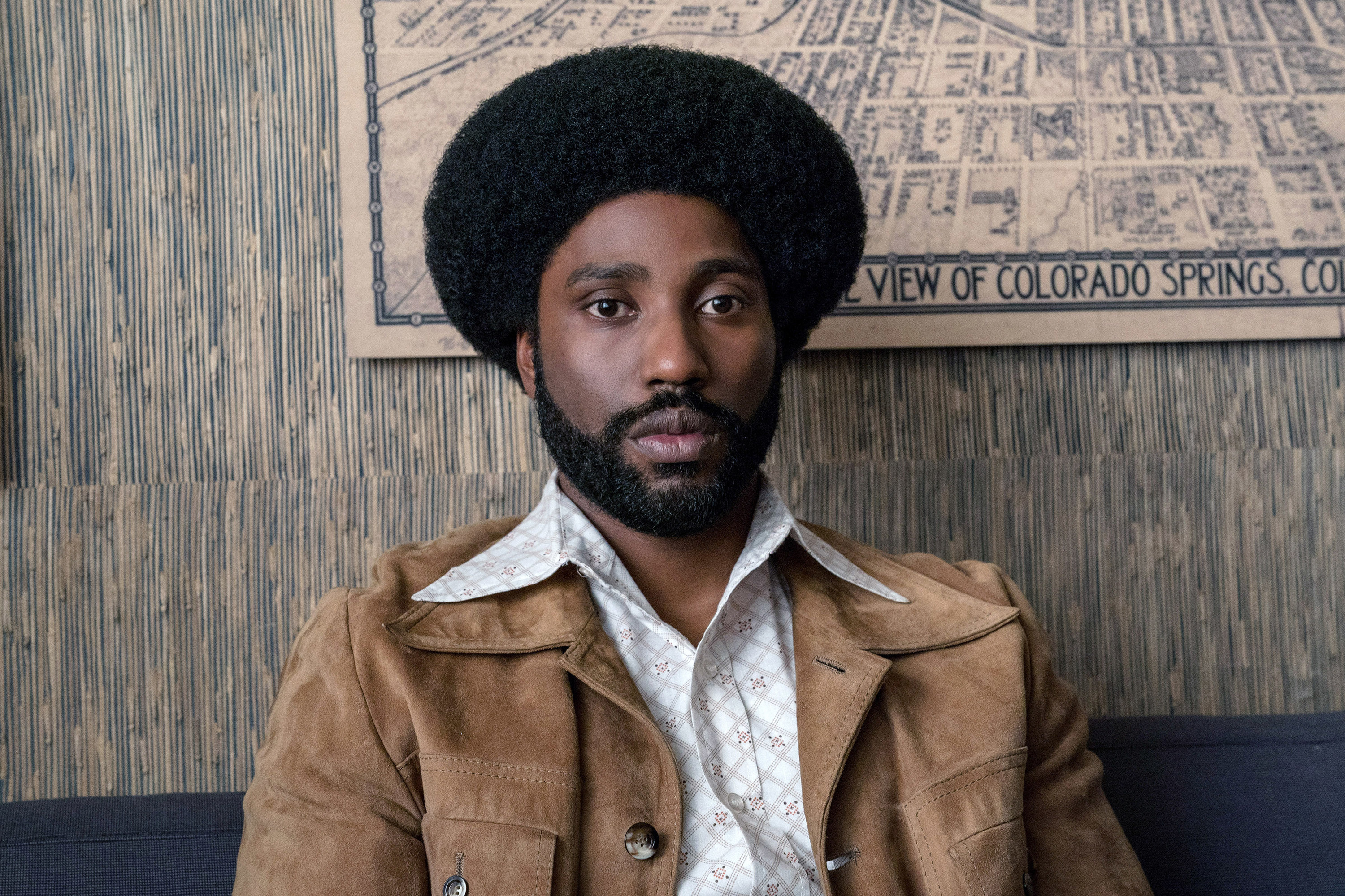 John David Washington with an Afro, beard, and &#x27;70s clothing