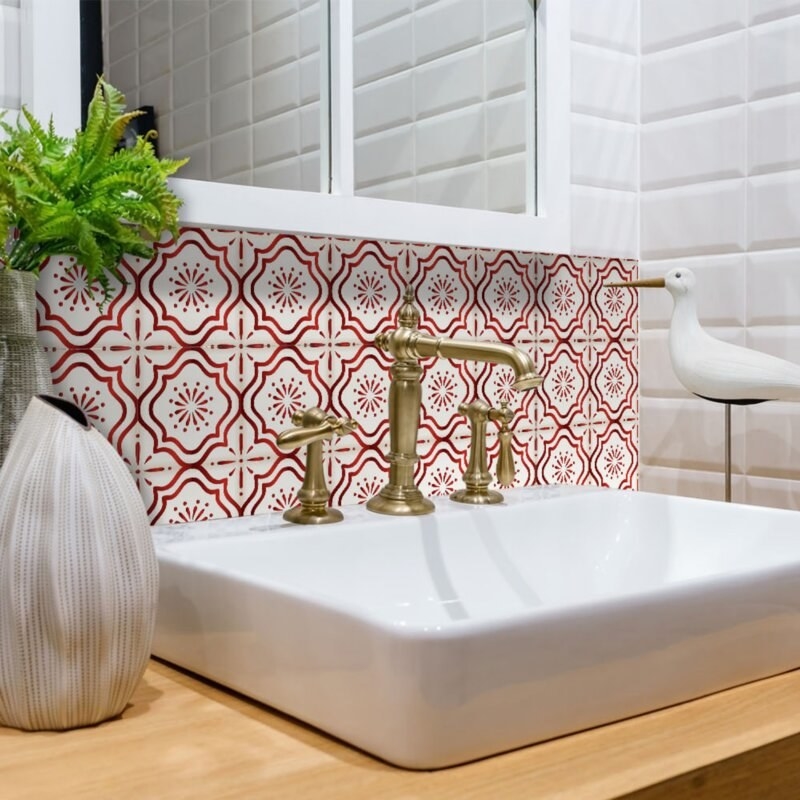 the red mosaic tiles behind a white sink