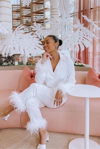 a model wearing the white set with matching white mules