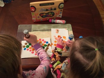 reviewer's children painting dots with the markers