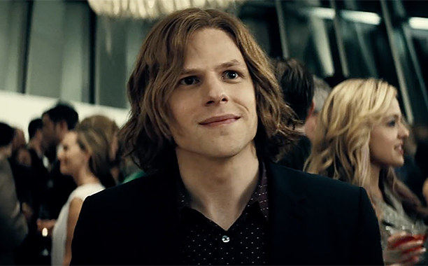 Jesse Eisenberg as Lex looking off-screen and smiling