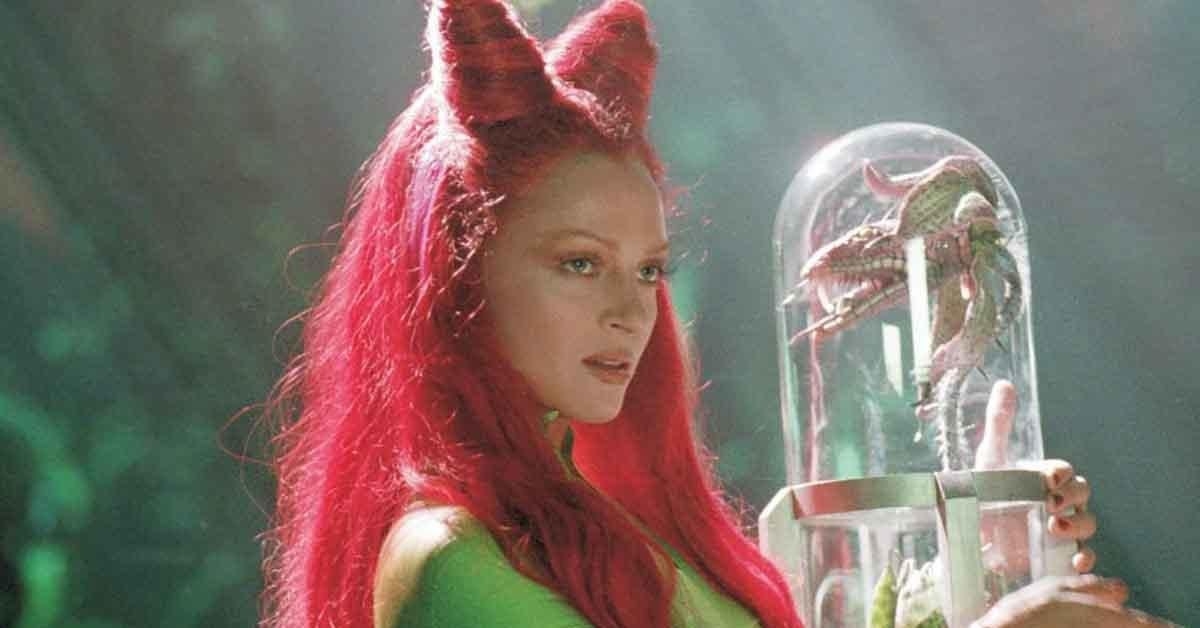 Uma Thurman as Poison Ivy holding an encased plant in her hands