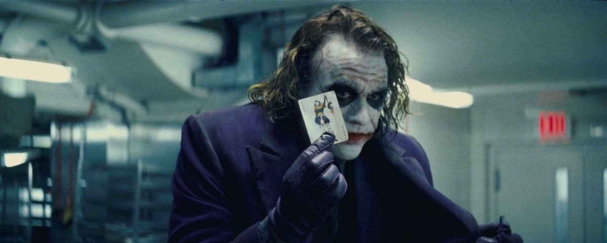 Heath Ledgers&#x27; Joker holds a joker card in his hand