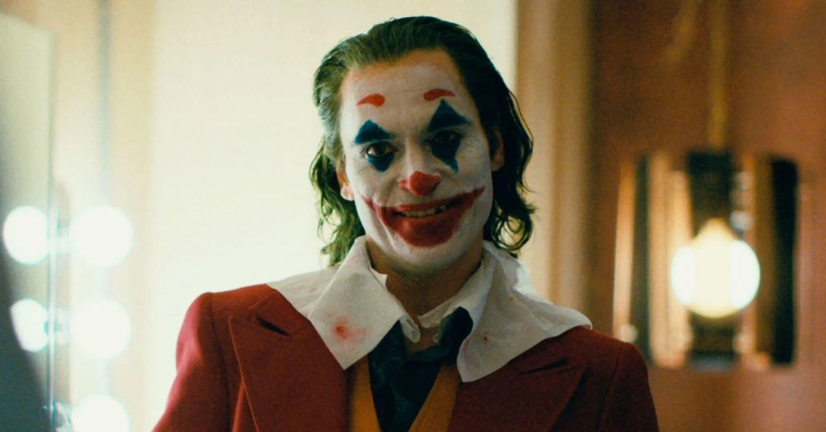 Joaquin Phoenix as the Joker smiling at the screen
