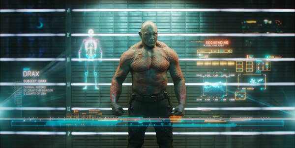 standing strong, Drax is scanned for his prison intake