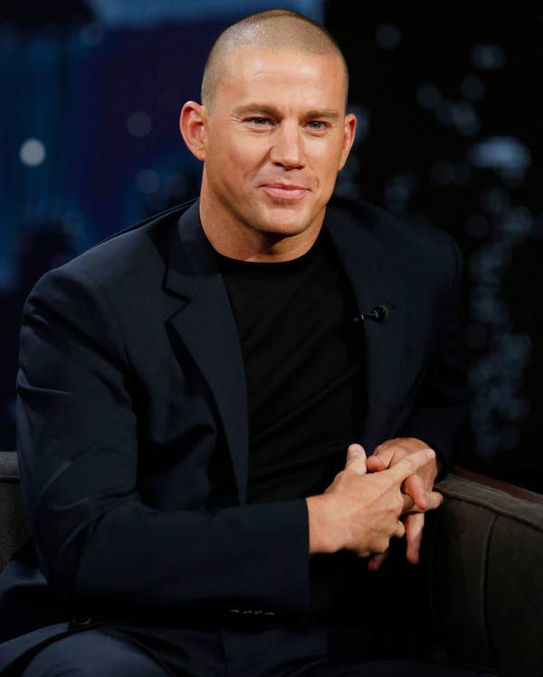 dressed casually in an open blazer, t-shirt, and jeans, Tatum leans against the arm of his chair on a talk show