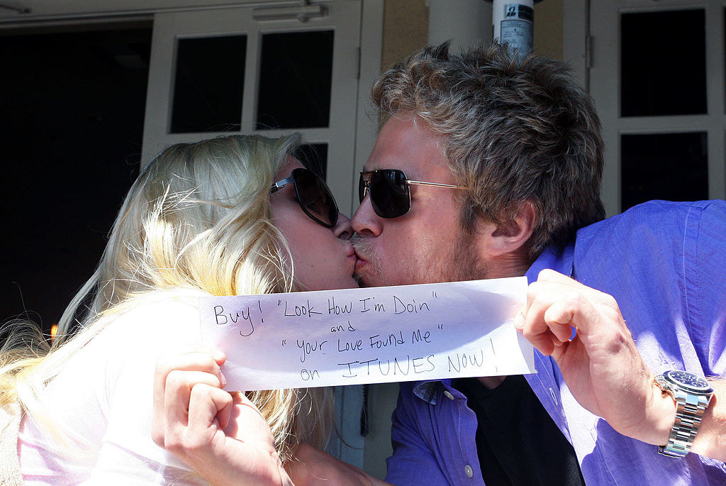 The two kissing while Spencer holds up a small sign telling people to buy their songs on iTunes