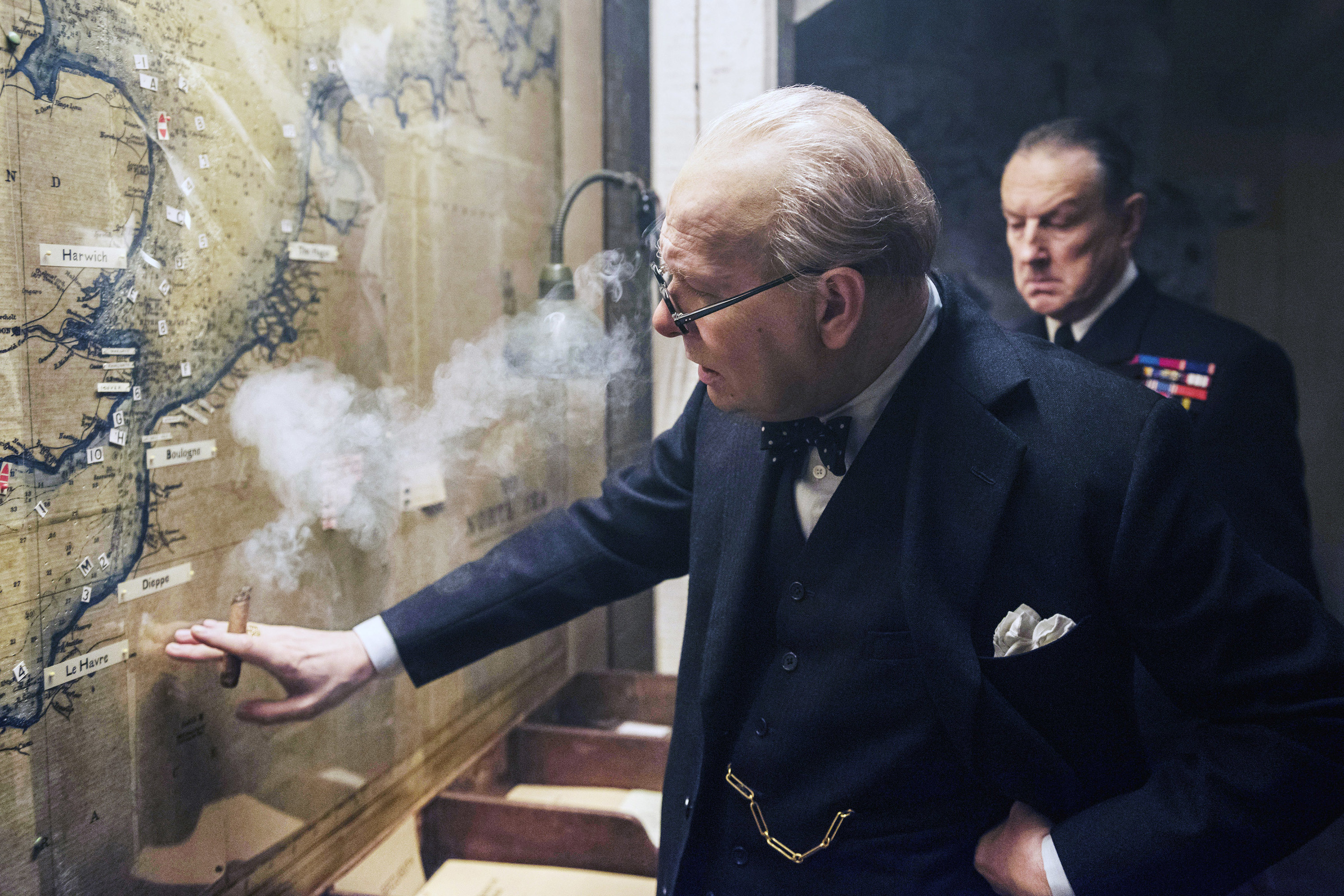 Oldman as Churchill touching a map with a cigar in his hand