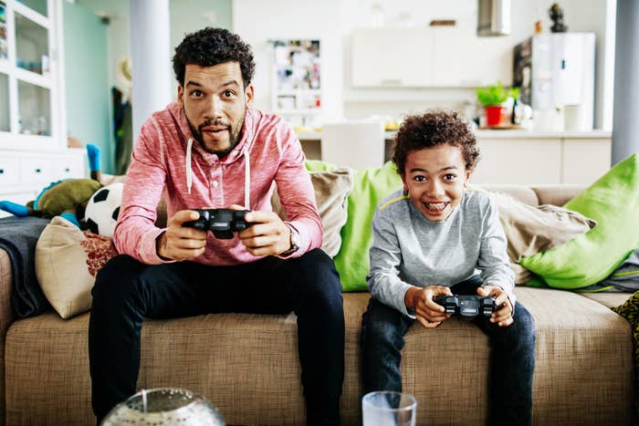 A father and son are having a blast playing a video game together