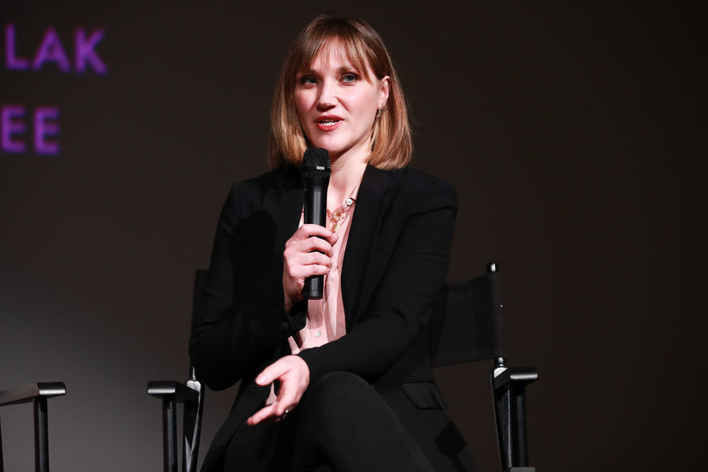 A woman speaking into a microphone at an event