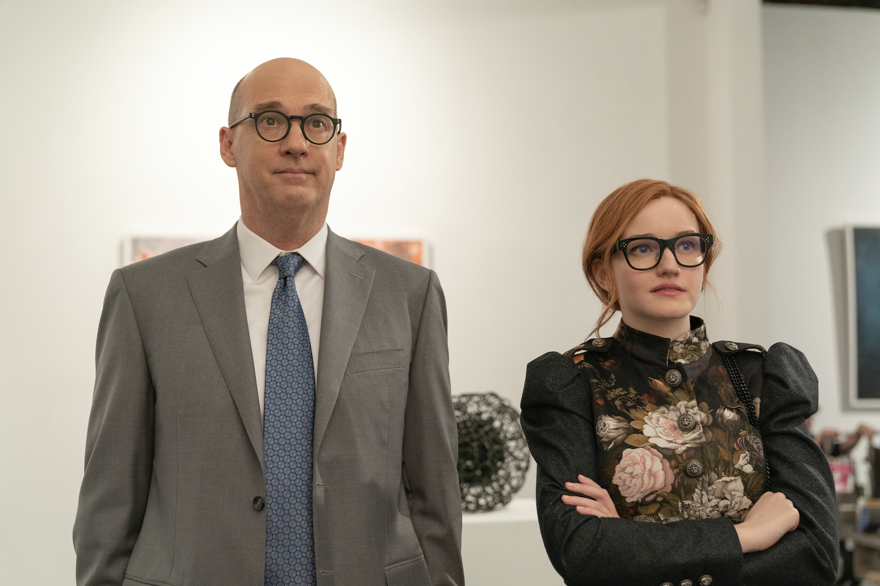 A man and a woman looking at art in a gallery