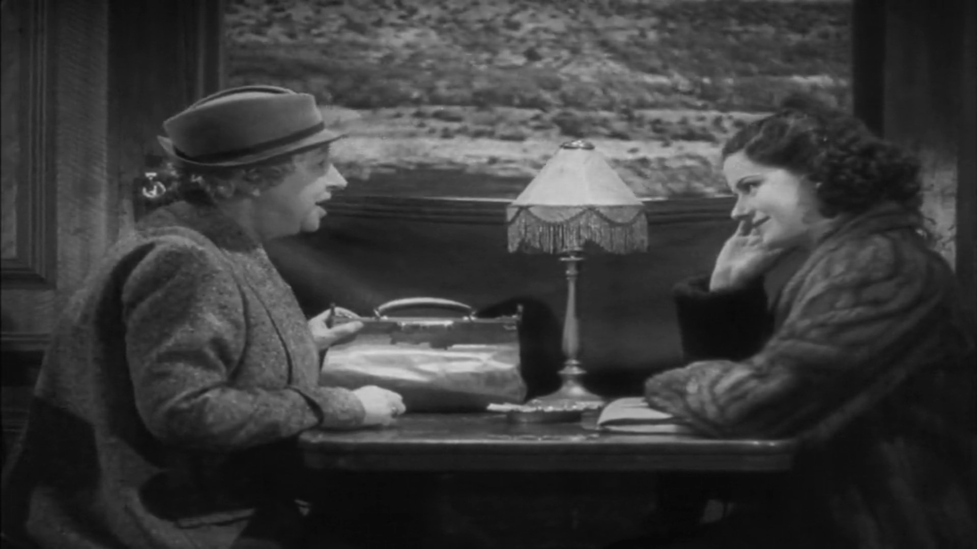 Margaret Lockwood and May Whitty chat in the dining car of a train