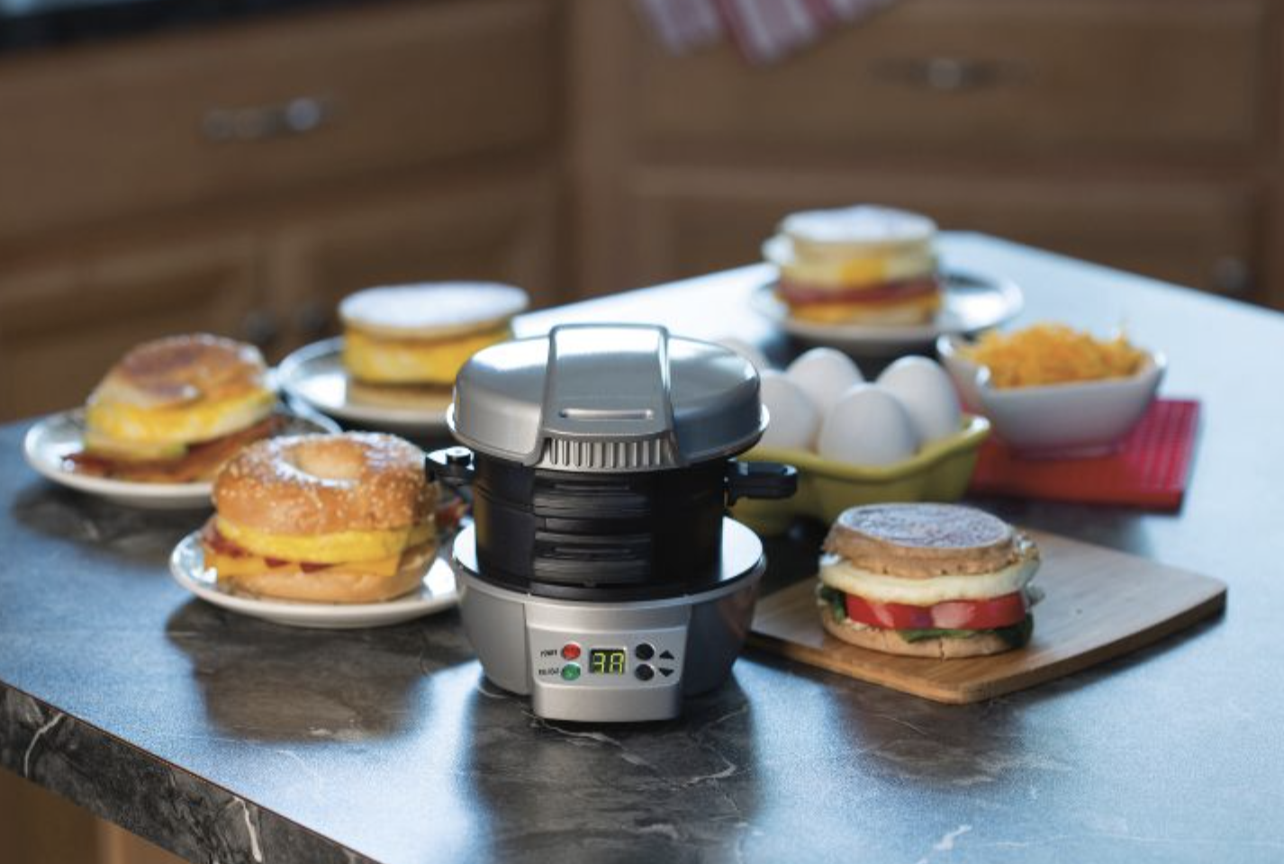 the breakfast sandwich maker with a bunch of breakfast sandwiches around it