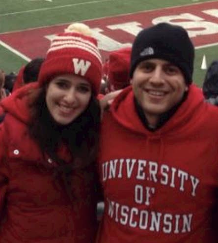 Max and Daniella smiling at a University of Wisconsin-Madison football game