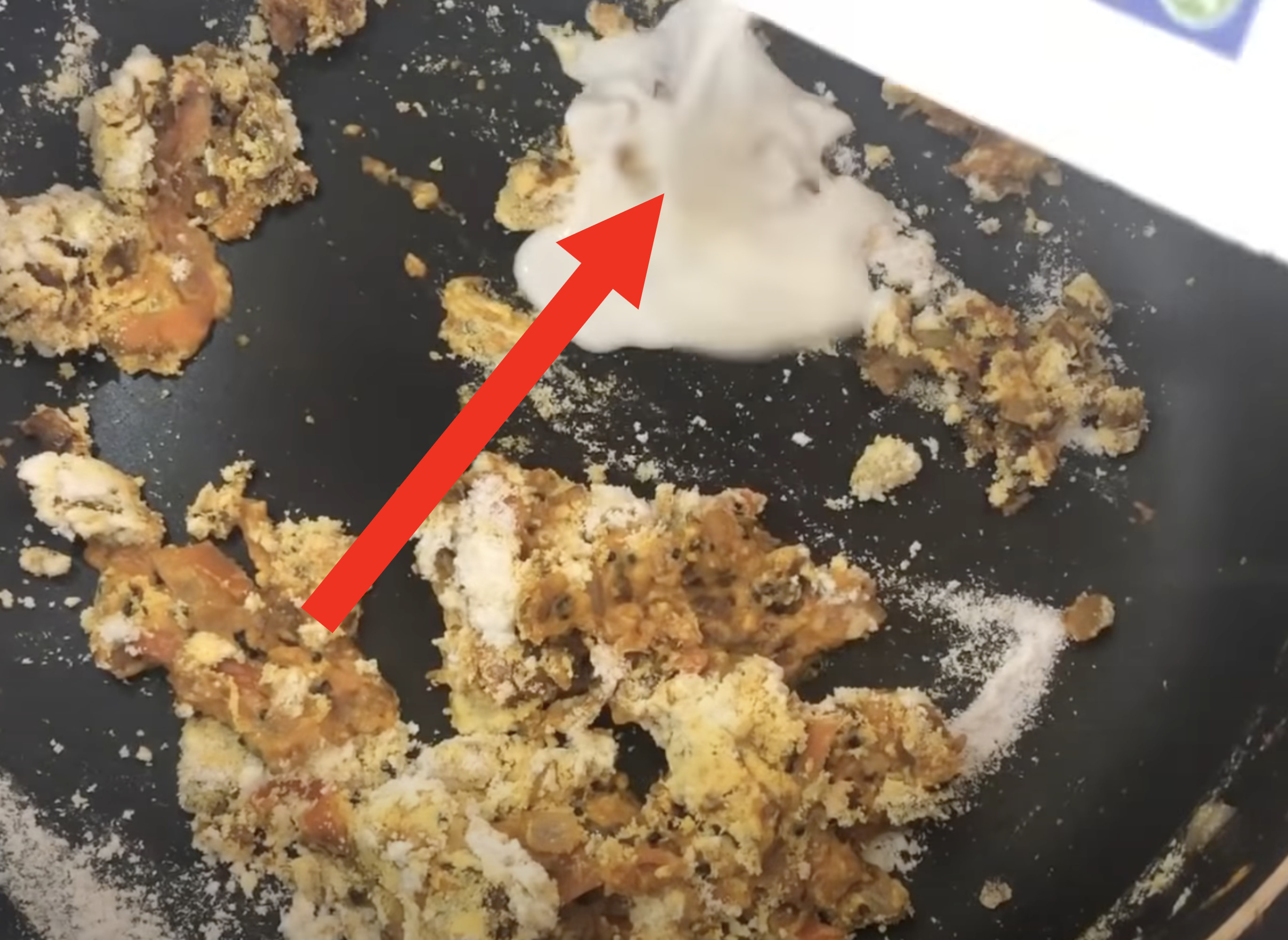 Arrow pointing to yogurt in the beginning of a curry dish