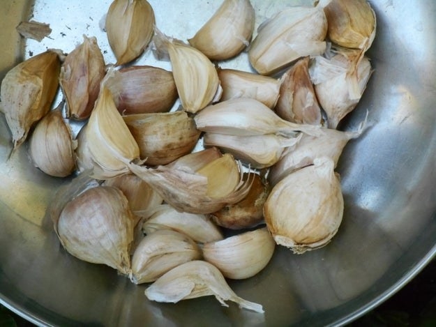 Lots of cloves of garlic in a metal frying pan