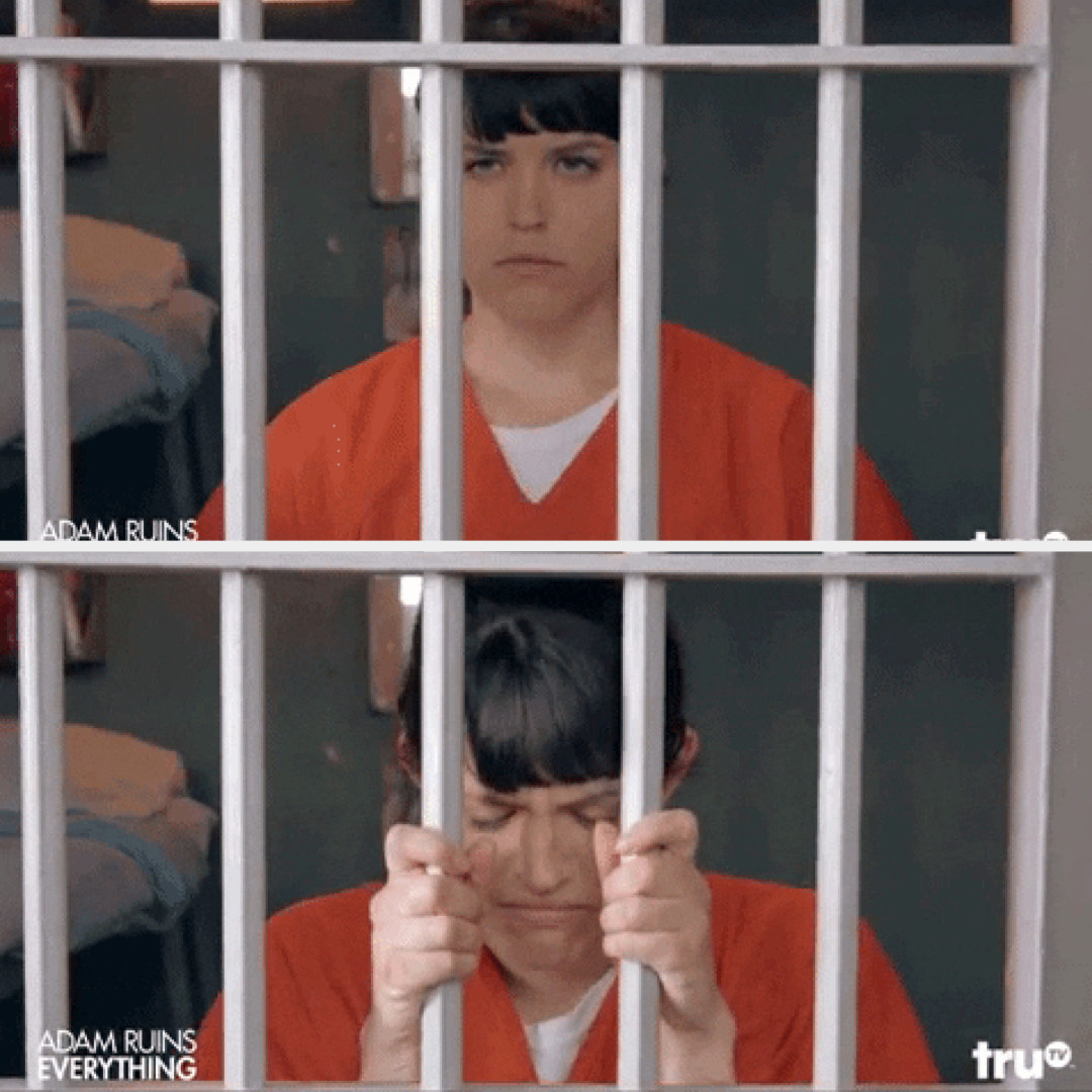 woman in jail looking sad