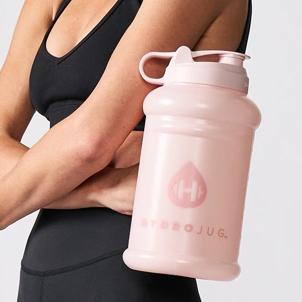 A Woman Holding a 64 Oz Water Bottle by HydroJug