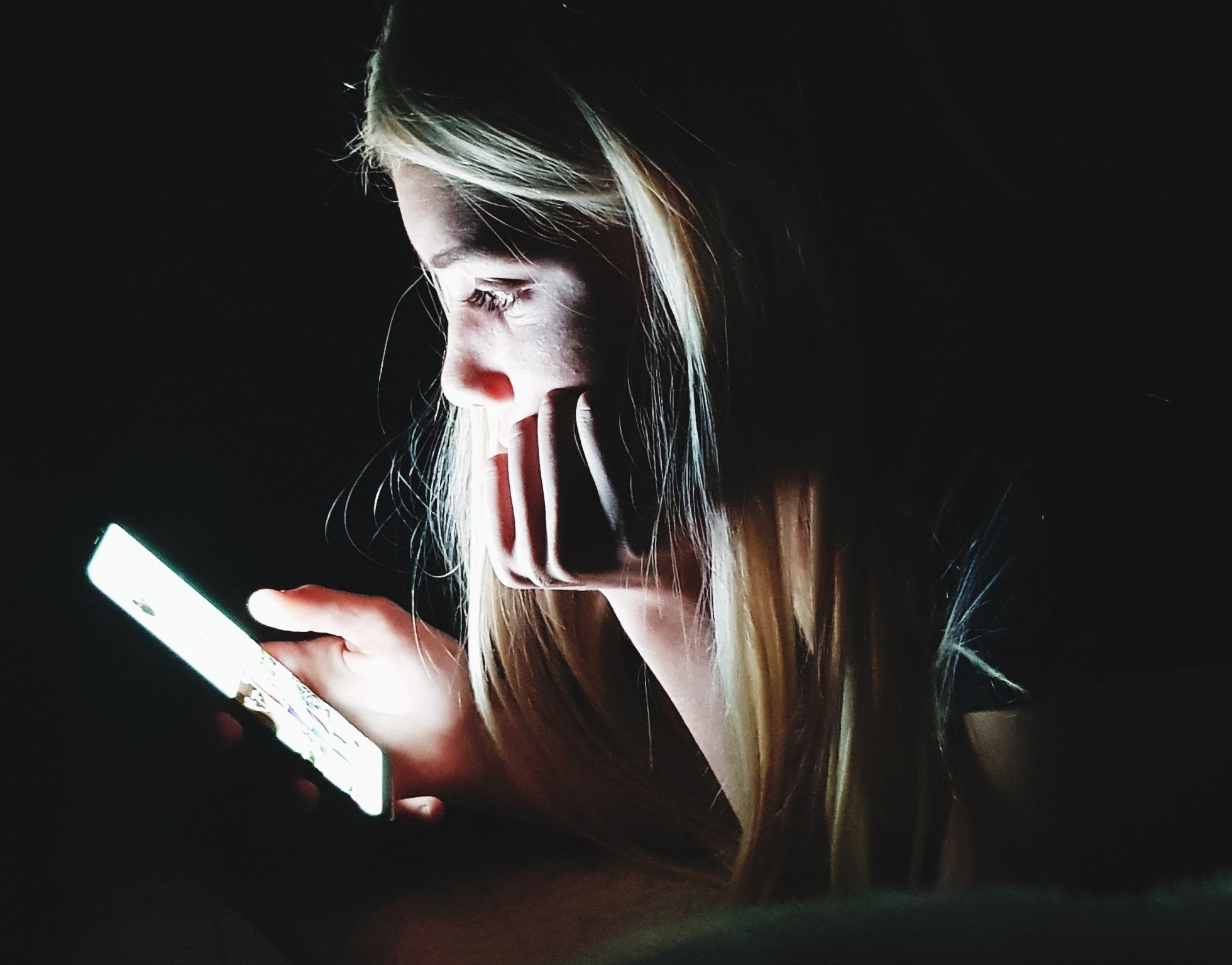girl on phone in dark