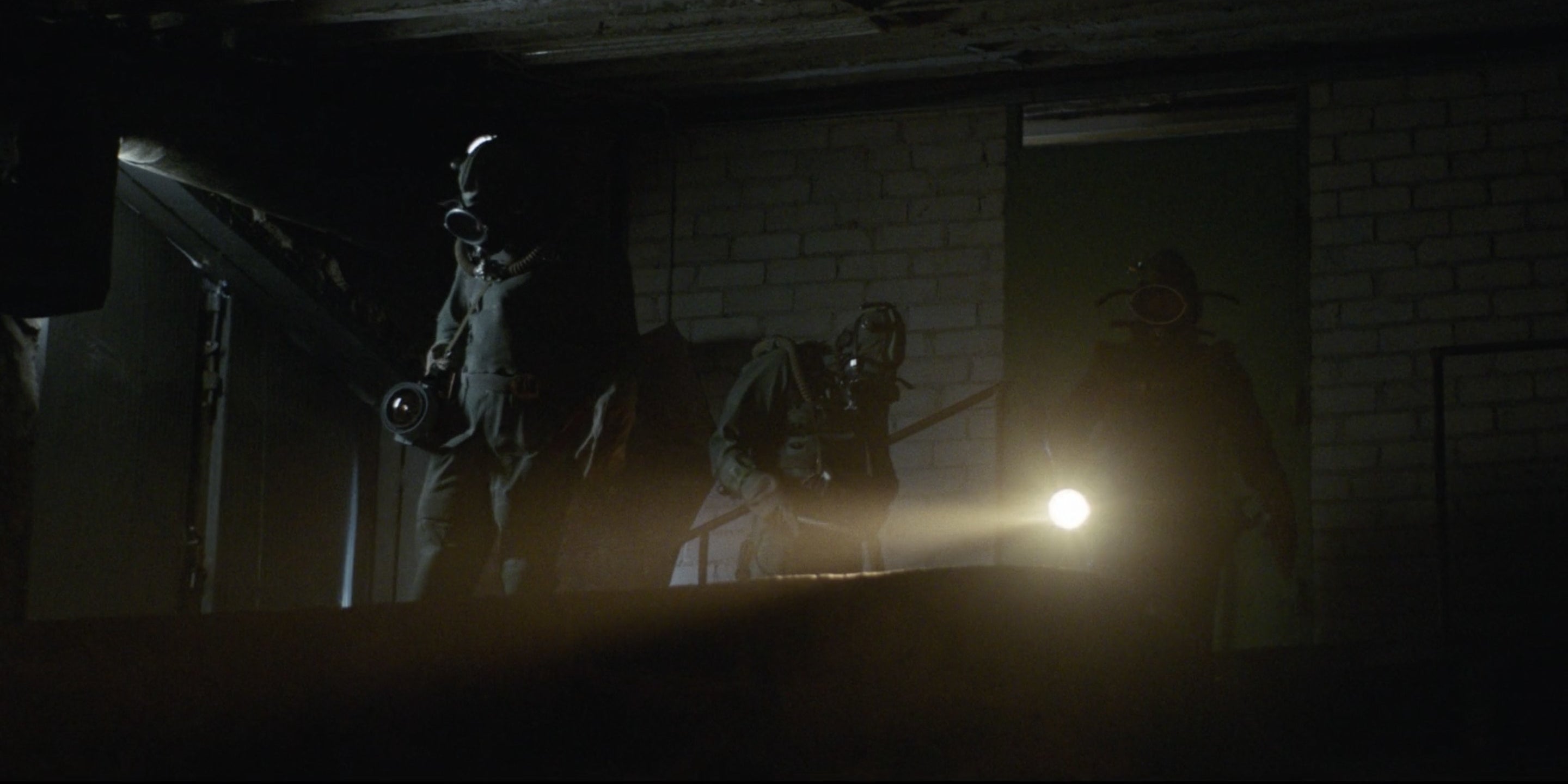 Men in hazmat suits with torches