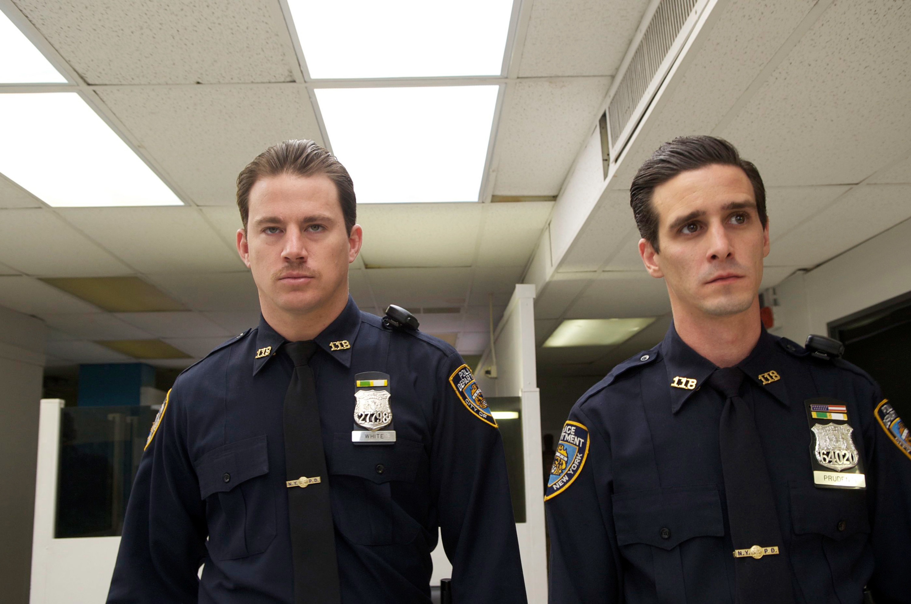Tatum in a cop uniform next to another cop