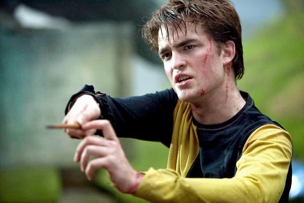 Robert Pattinson as Cedric Diggory threateningly holding a wand with two hands