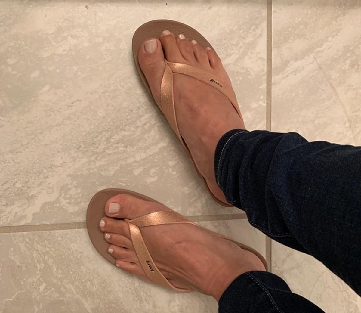 reviewer photo of flip-flops with rose gold straps