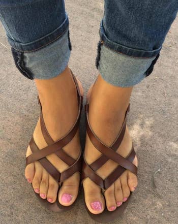 reviewer wearing the sandals in brown
