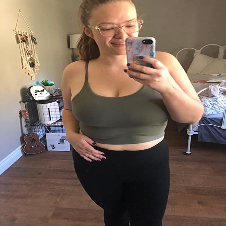 Reviewer wearing the olive green padded yoga tank