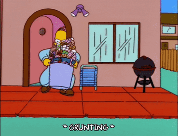 Gif of Homer Simpson grunting as he takes out a large bin of garbage