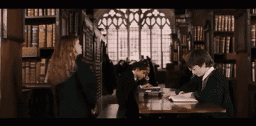 Hermione and Harry in the library with books