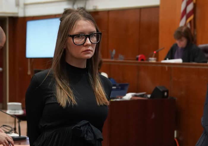 Anna walks in the courtroom and looks at a camera