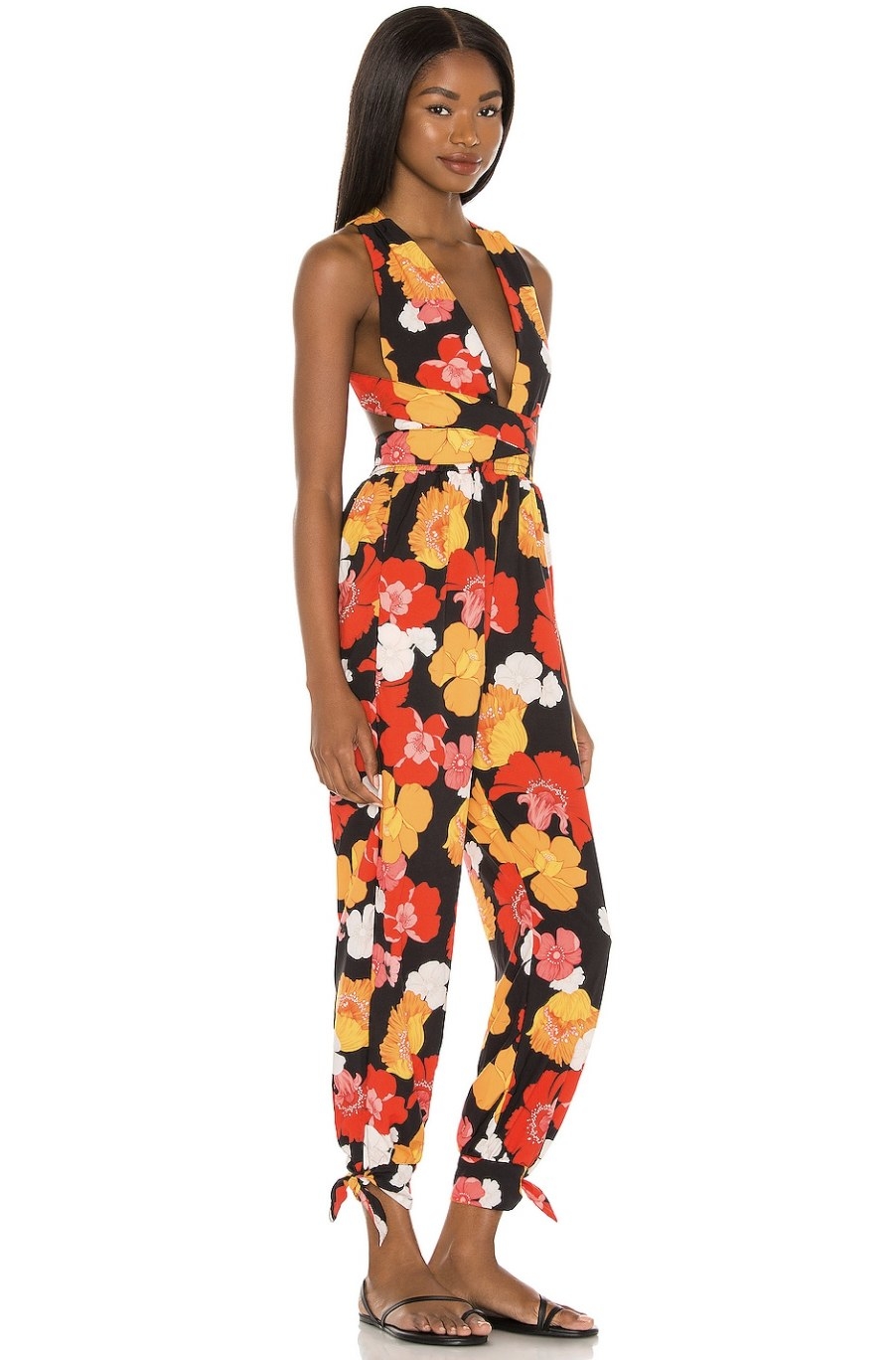 Model wearing the black jumpsuit with red and yellow flowers