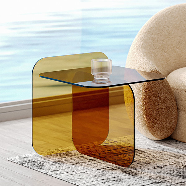 the amber acrylic table near a chair and window
