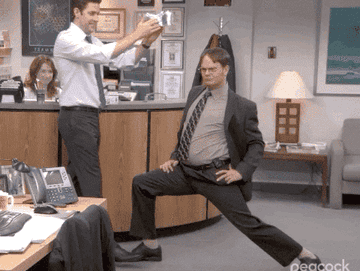gif of jim putting a crown on dwight in a scene from the office