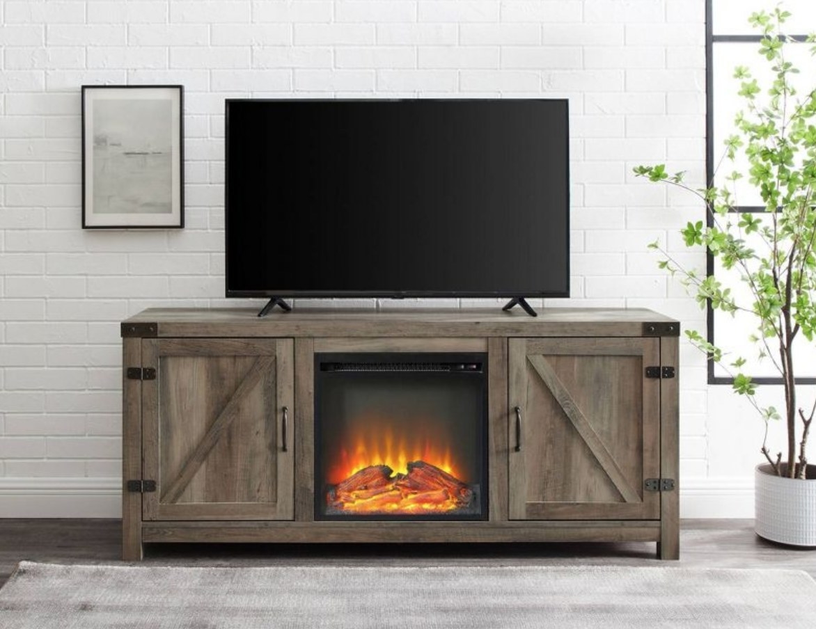 A grey wash double door farmhouse tv stand with an electric fireplace