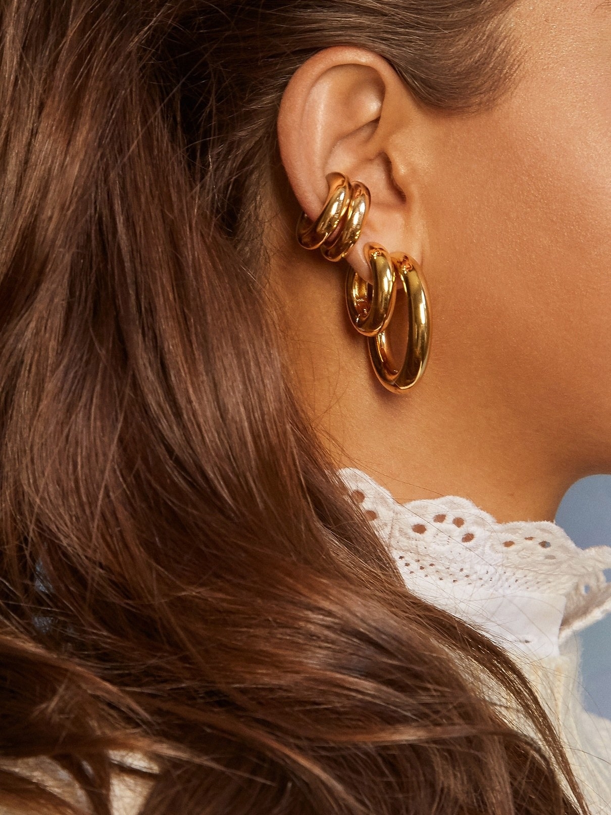 model wearing the three different sized earrings
