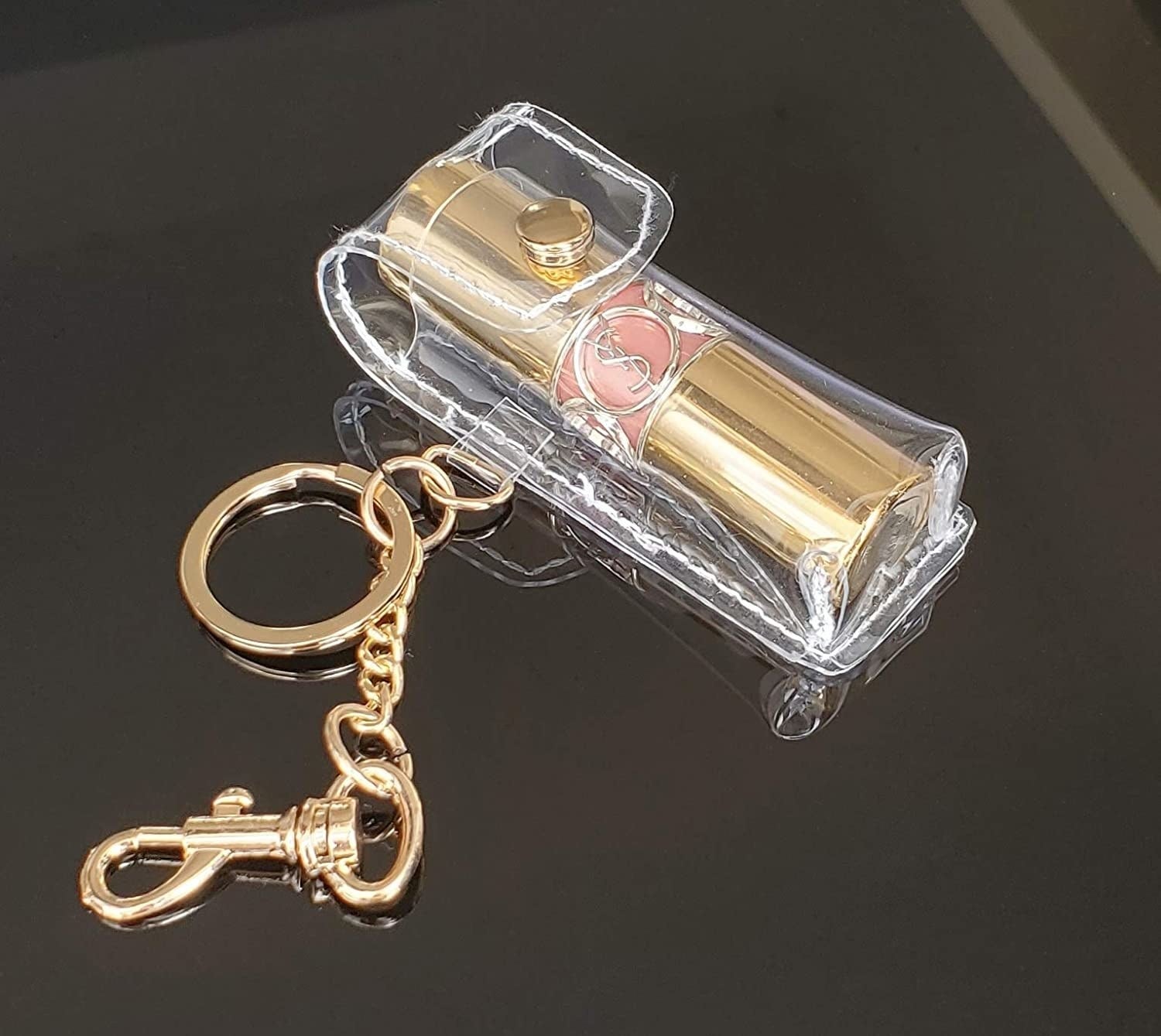 The lipstick holder with a tube of lipstick inside on a plain background