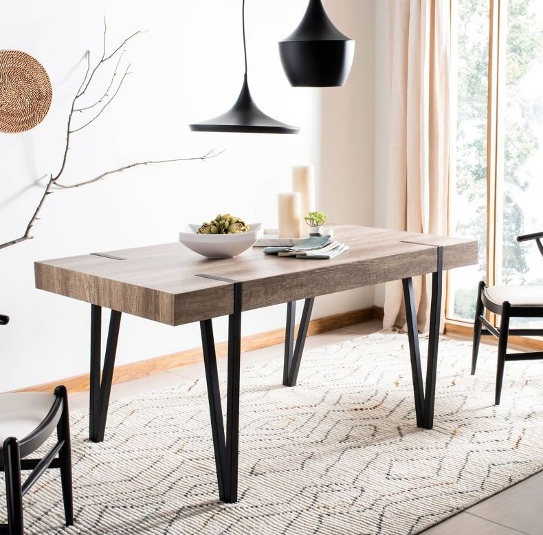 A wood top dining table with black metal legs