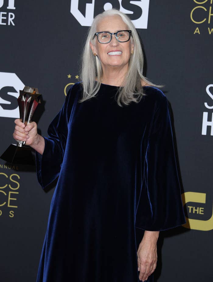 Jane smiles while holding her award