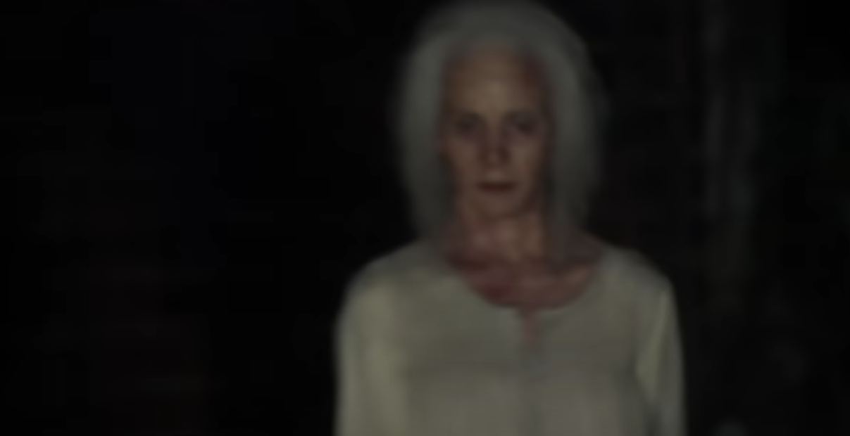 The old woman standing in the dark at night