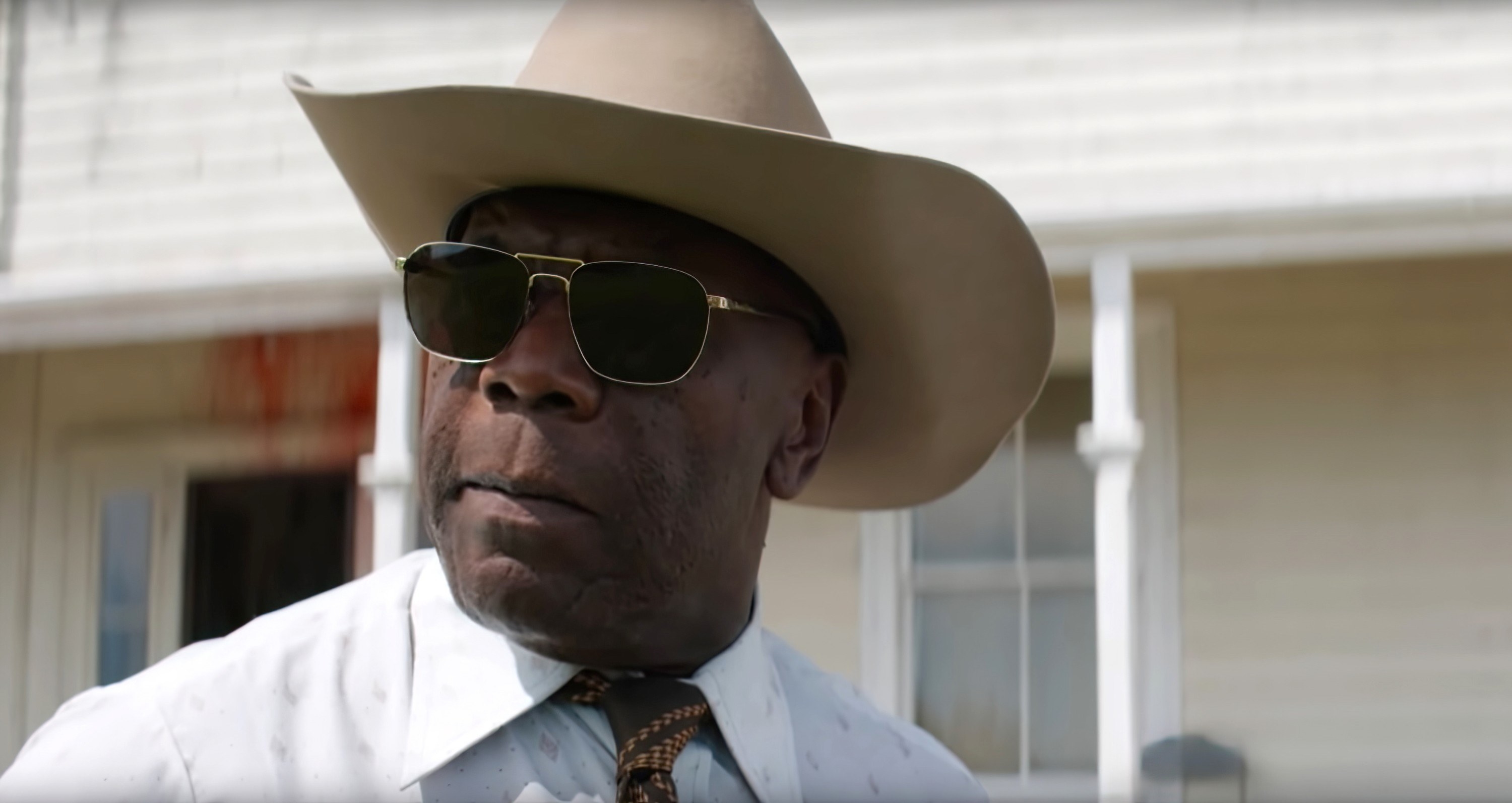 James Gaylyn as the sheriff, wearing a cowboy hat and sunglasses